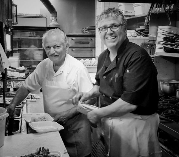 OWNERS OF GRECOS, PREPARING MEDITERRANEAN GREEK MEALS